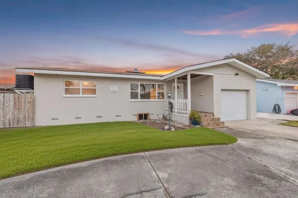 a view of a house with a yard and garage