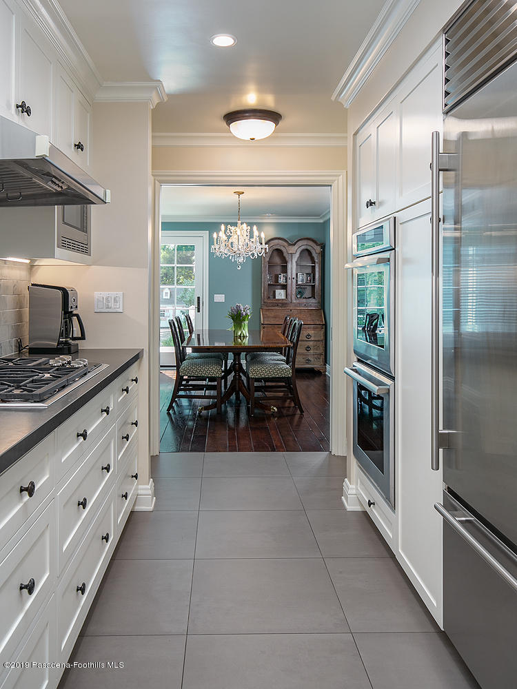 504 Arbor Street Pasadena, CA 91105 - Photo 12 of 46 a kitchen with stainless steel appliances kitchen island granite countertop a refrigerator and a stove top oven