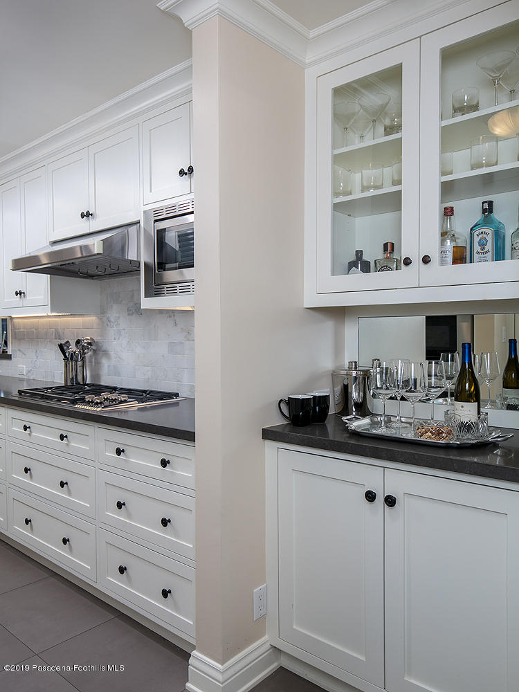 504 Arbor Street Pasadena, CA 91105 - Photo 13 of 46 a kitchen with granite countertop a sink and cabinets