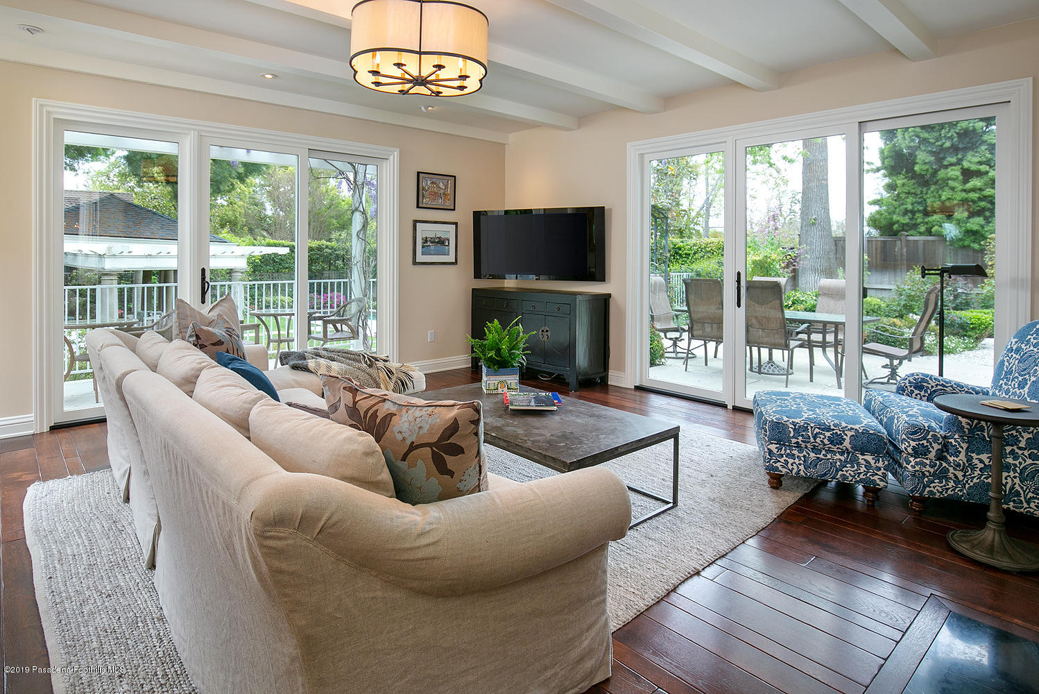 504 Arbor Street Pasadena, CA 91105 - Photo 14 of 46 a living room with furniture a large window and a flat screen tv