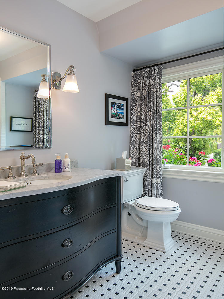 504 Arbor Street Pasadena, CA 91105 - Photo 33 of 46 a bathroom with a toilet a sink a mirror a window and vanity
