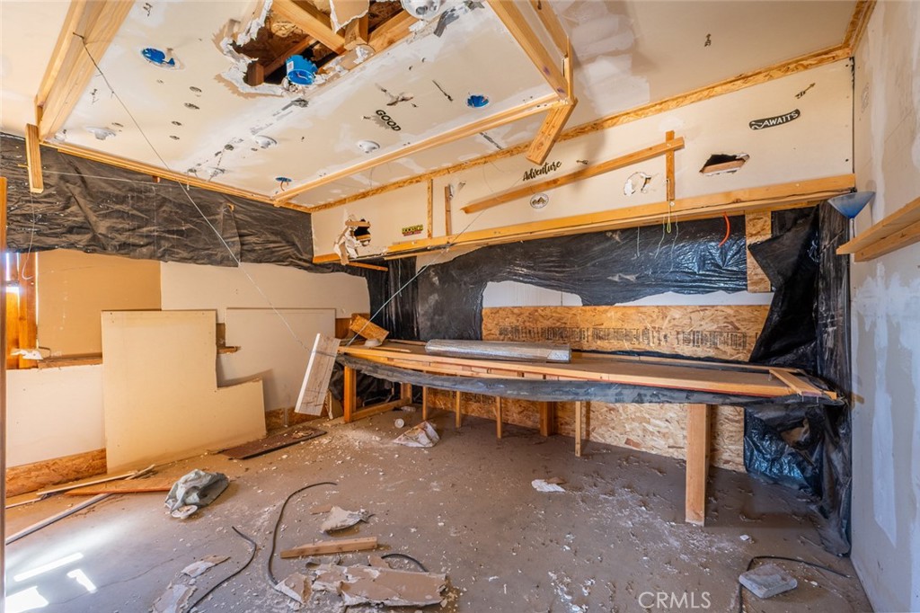 67722 Pole Line Road Twentynine Palms, CA 92277 - Photo 11 of 33 a view of a patio with table and chairs with wooden floor