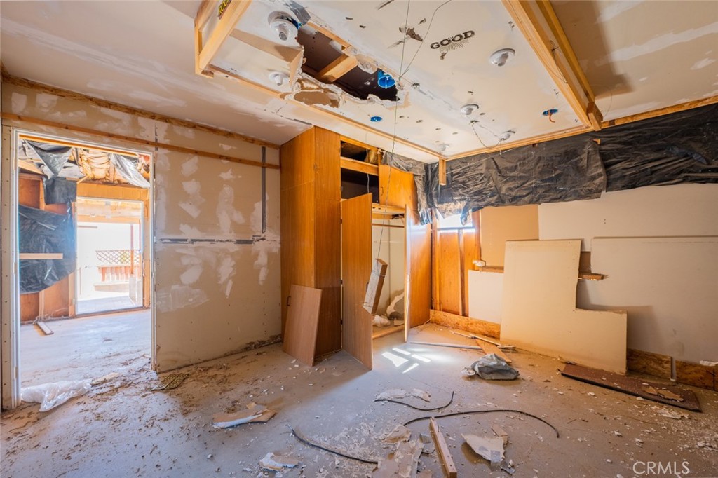 67722 Pole Line Road Twentynine Palms, CA 92277 - Photo 12 of 33 a view of a room with wooden floor and windows