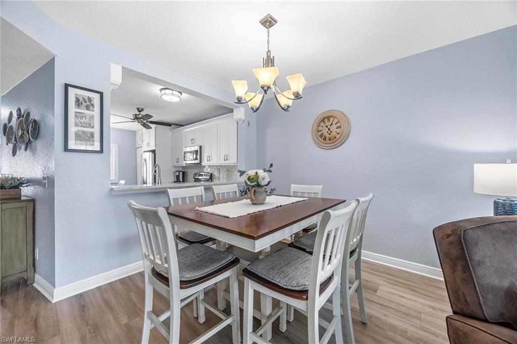 9022 Michael Circle, Unit 3 Naples, FL 34113 - Photo 11 of 29 a view of a dining room with a table and chairs