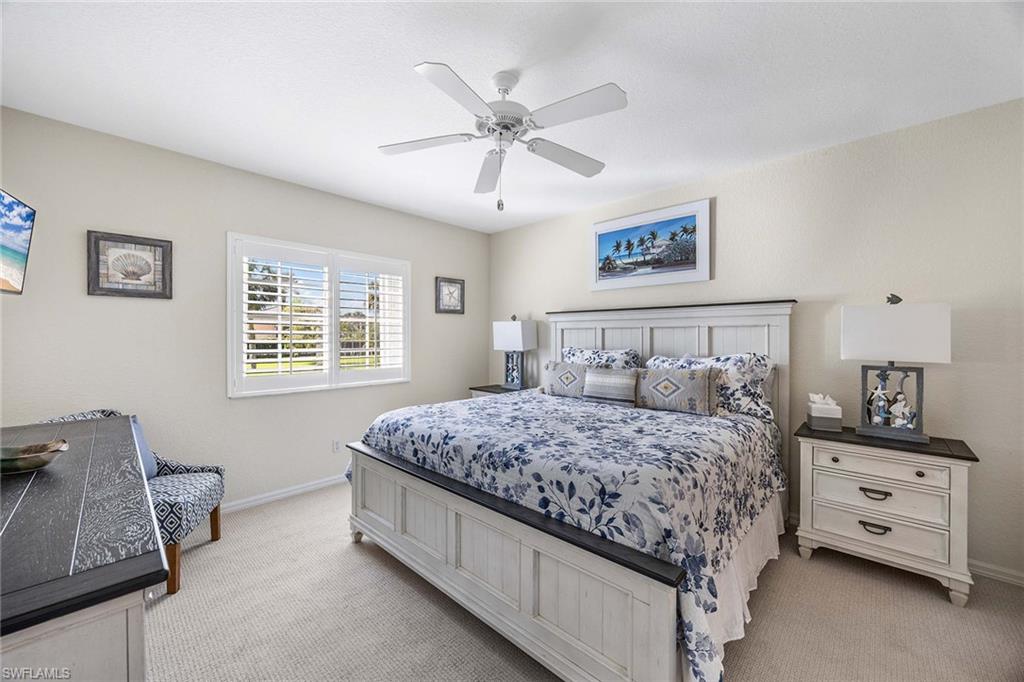 9022 Michael Circle, Unit 3 Naples, FL 34113 - Photo 17 of 29 a bedroom with a bed and a couch