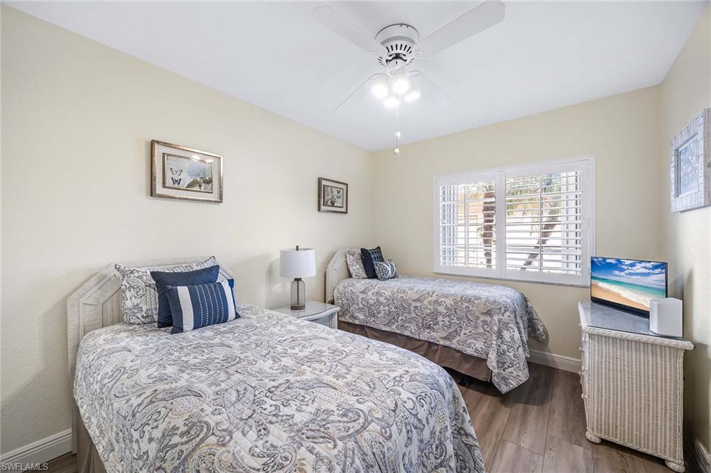 9022 Michael Circle, Unit 3 Naples, FL 34113 - Photo 21 of 29 a bedroom with two beds and a window