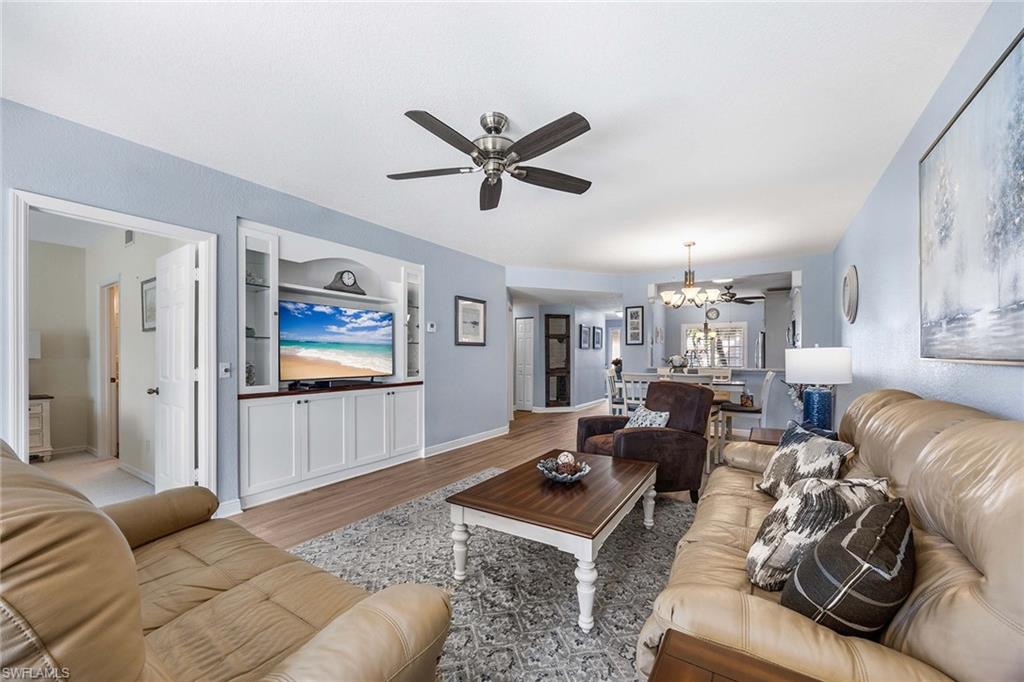 9022 Michael Circle, Unit 3 Naples, FL 34113 - Photo 9 of 29 a living room with furniture and a flat screen tv