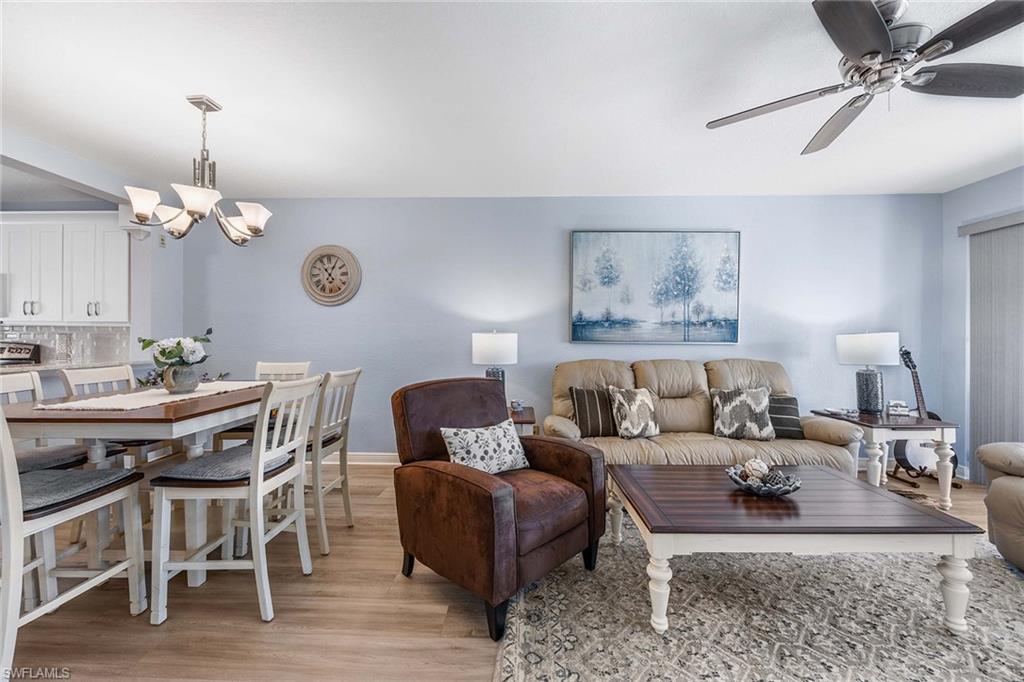 9022 Michael Circle, Unit 3 Naples, FL 34113 - Photo 10 of 29 a living room with furniture chandelier and a table