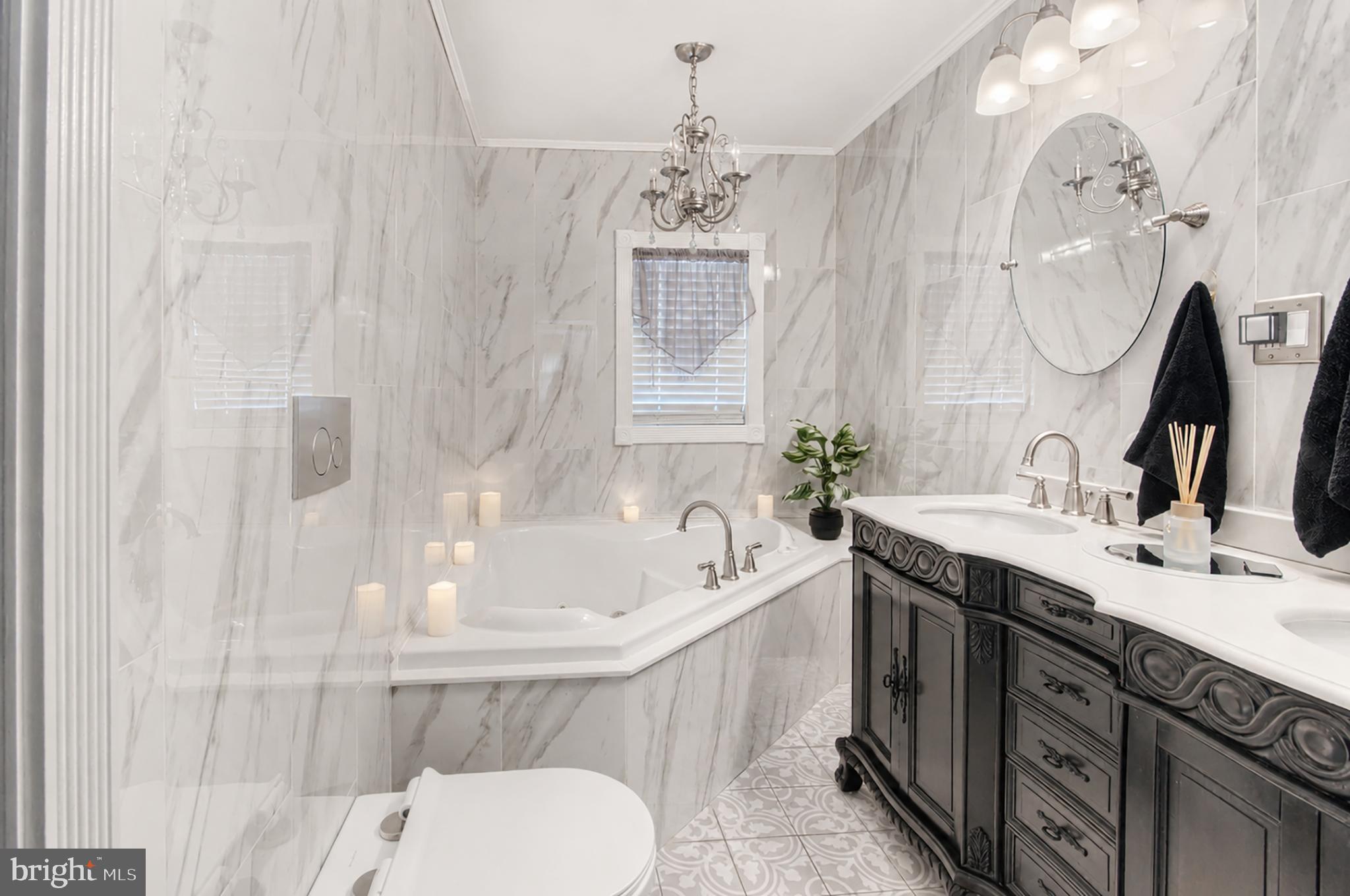 32 Bryant Road Turnersville, NJ 08012 - Photo 17 of 33 a spacious bathroom with a sink mirror and a bathtub