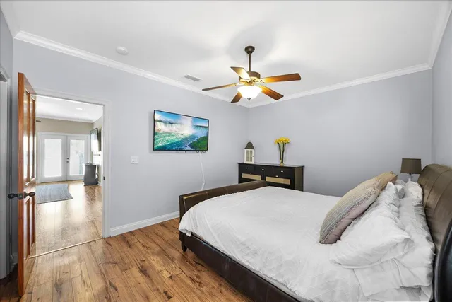 a bedroom with a bed and a chandelier