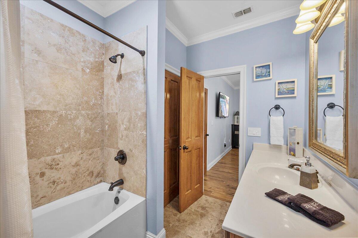 210 Grand Key Loop West Destin, FL 32541 - Photo 15 of 46 a bathroom with a tub shower sink and mirror