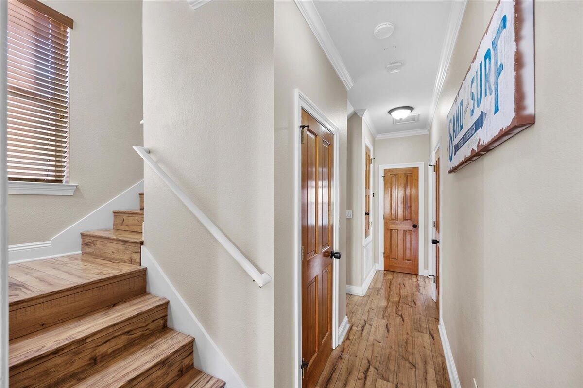 210 Grand Key Loop West Destin, FL 32541 - Photo 18 of 46 a view of a hallway with wooden floor and staircase