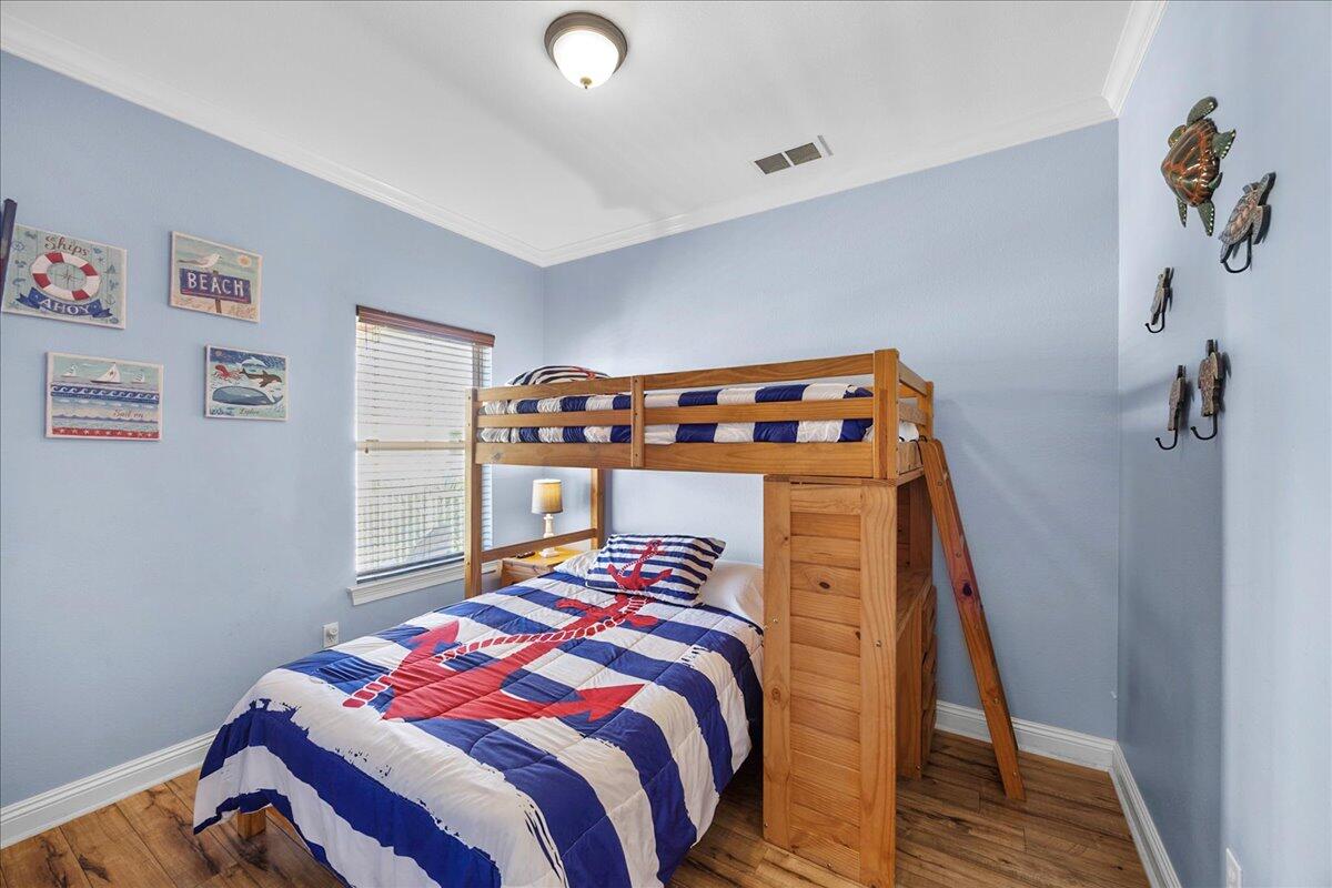 210 Grand Key Loop West Destin, FL 32541 - Photo 20 of 46 a bedroom with a bed and a window