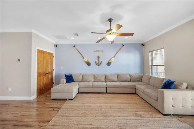 a living room with furniture and wooden floor
