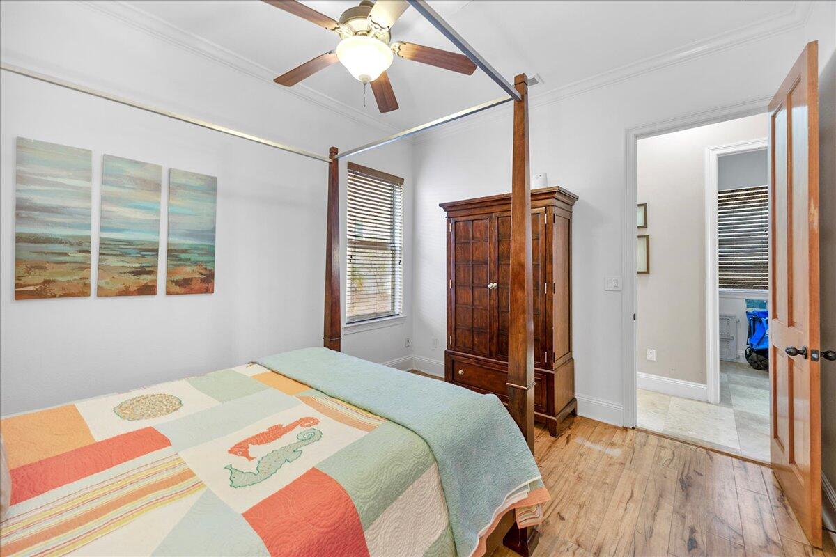 210 Grand Key Loop West Destin, FL 32541 - Photo 25 of 46 a bedroom with a bed dresser and a window