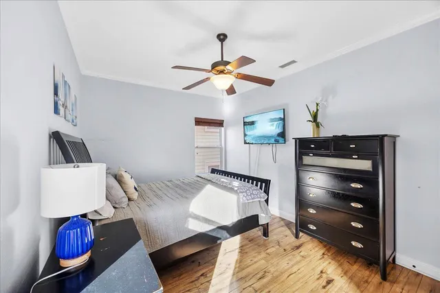 a bedroom with a bed and ceiling fan