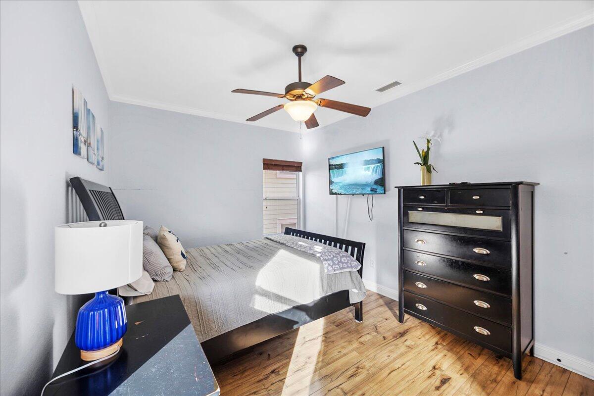 210 Grand Key Loop West Destin, FL 32541 - Photo 27 of 46 a bedroom with a bed and ceiling fan