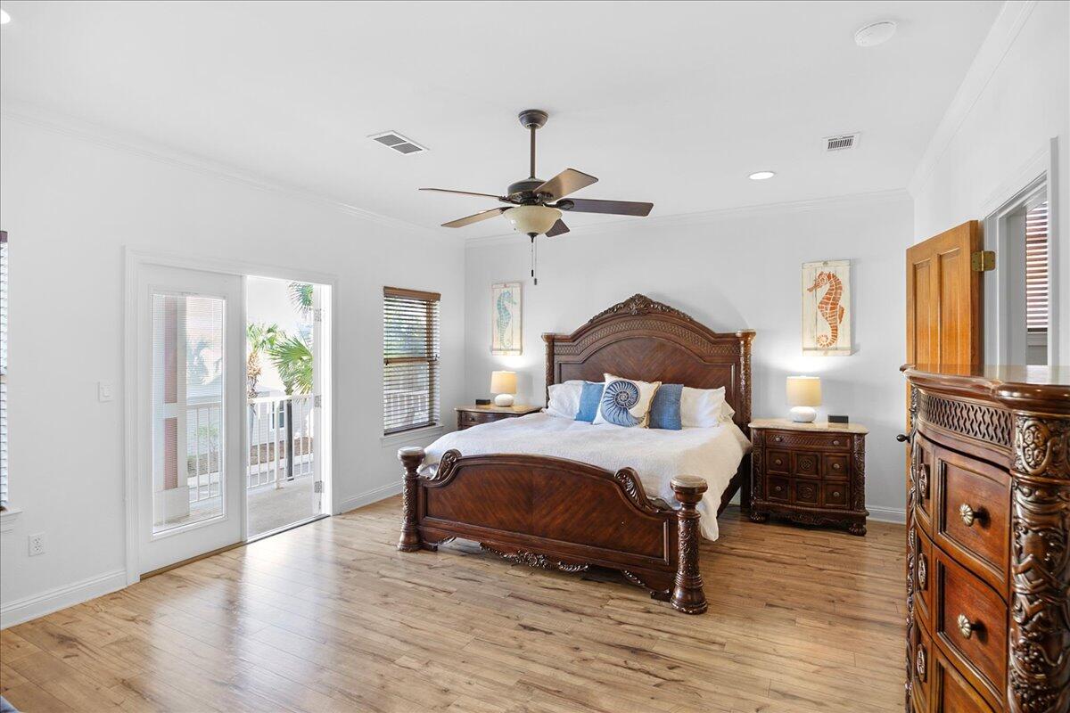 210 Grand Key Loop West Destin, FL 32541 - Photo 30 of 46 a bedroom with a bed and a table