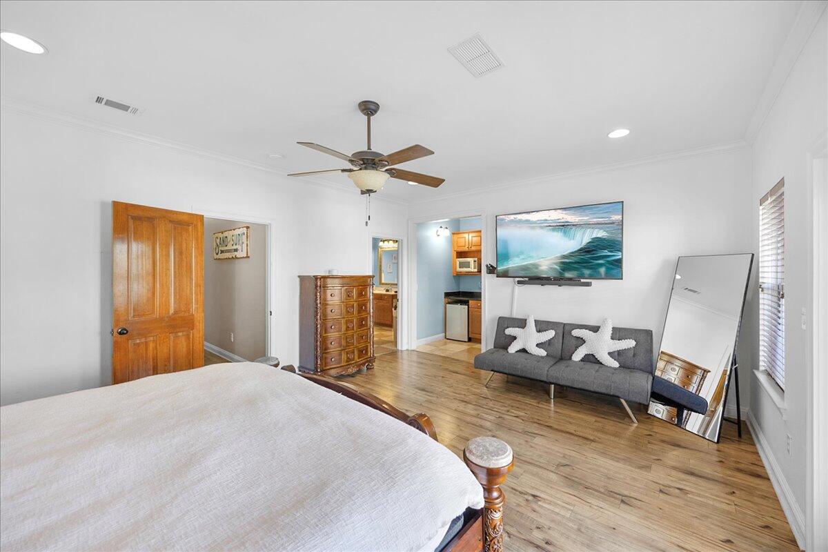 210 Grand Key Loop West Destin, FL 32541 - Photo 31 of 46 a bedroom with a bed and wooden floor