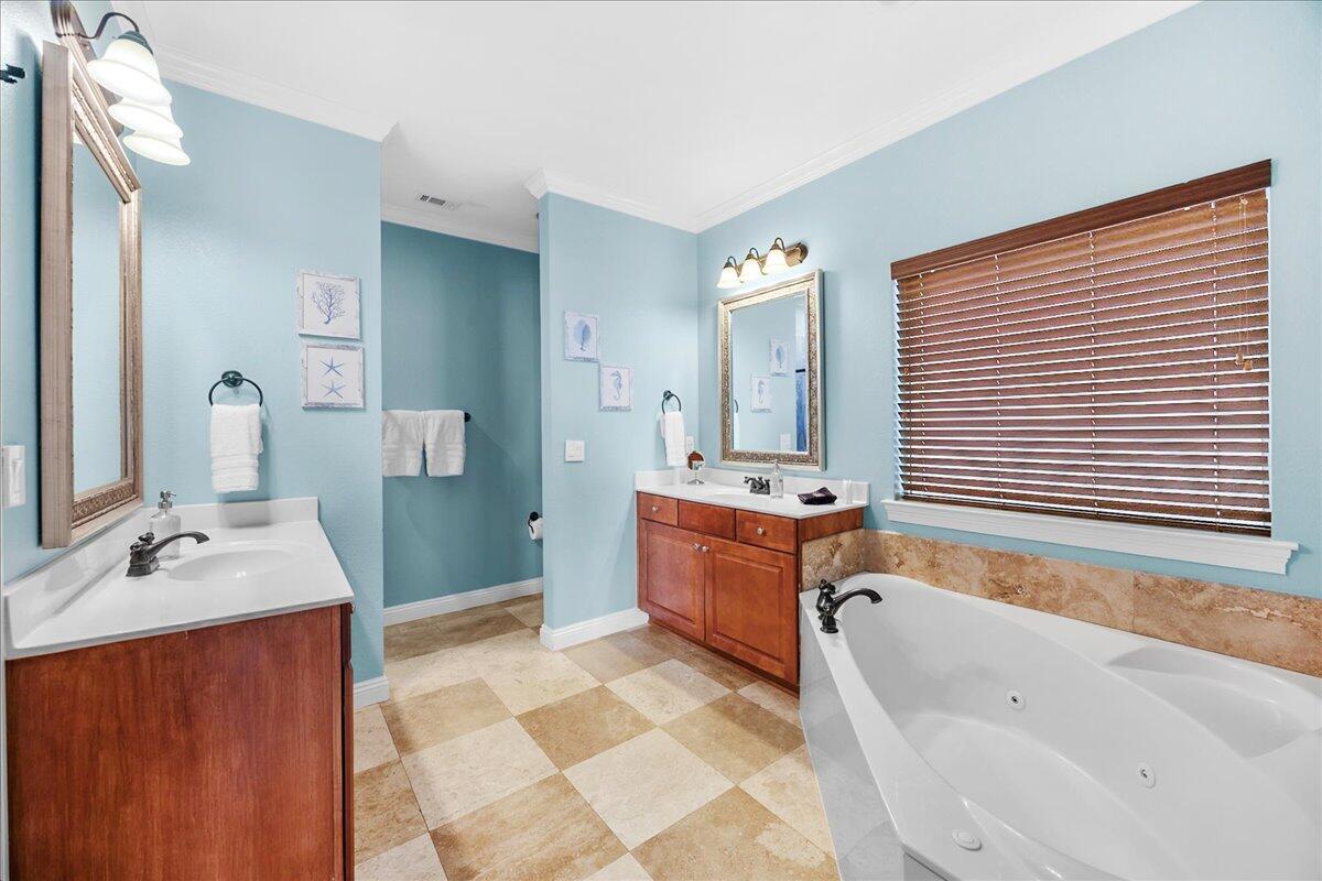 210 Grand Key Loop West Destin, FL 32541 - Photo 33 of 46 a bathroom with a tub sink and mirror