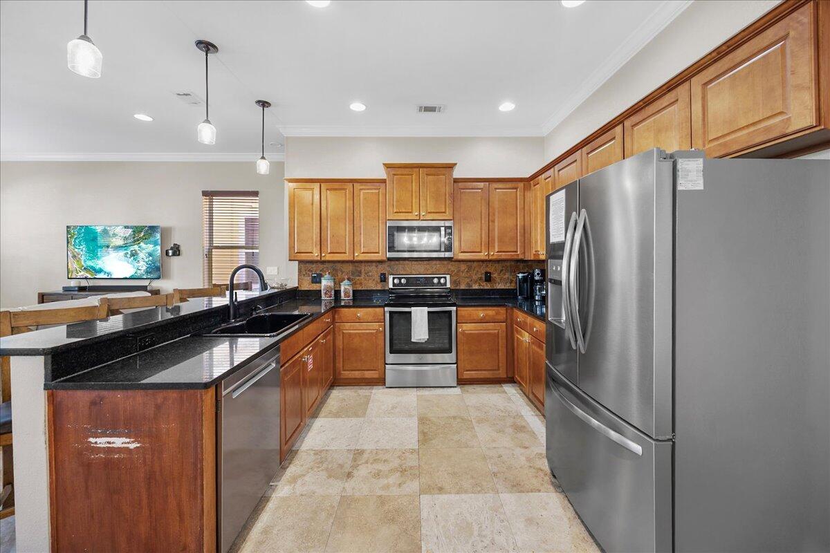 210 Grand Key Loop West Destin, FL 32541 - Photo 35 of 46 a kitchen with stainless steel appliances granite countertop a refrigerator a sink and a stove