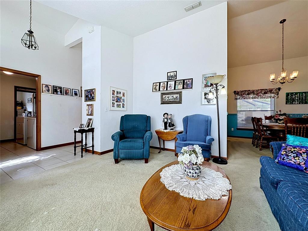 1681 East Spring Ridge Circle Winter Garden, FL 34787 - Photo 8 of 70 a living room with furniture and a chandelier