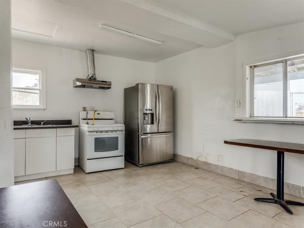 396 Pier Avenue Oceano, CA 93445 - Photo 11 of 24 a kitchen with a stove a sink and a refrigerator