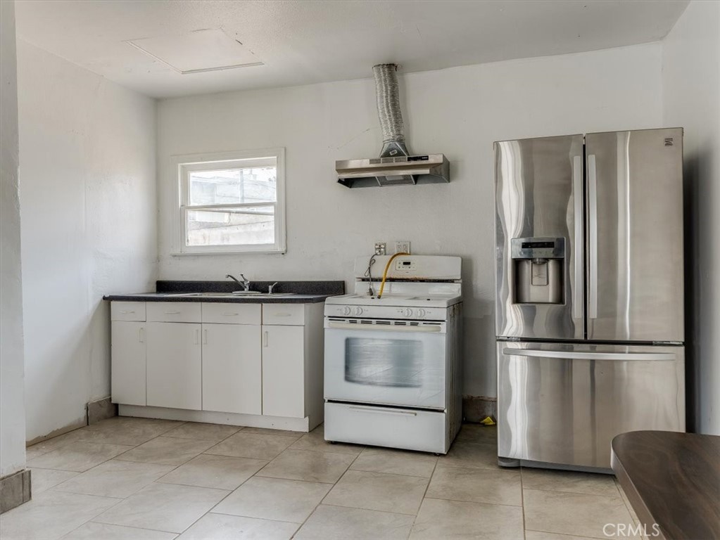 396 Pier Avenue Oceano, CA 93445 - Photo 12 of 24 a kitchen with appliances cabinets and a window