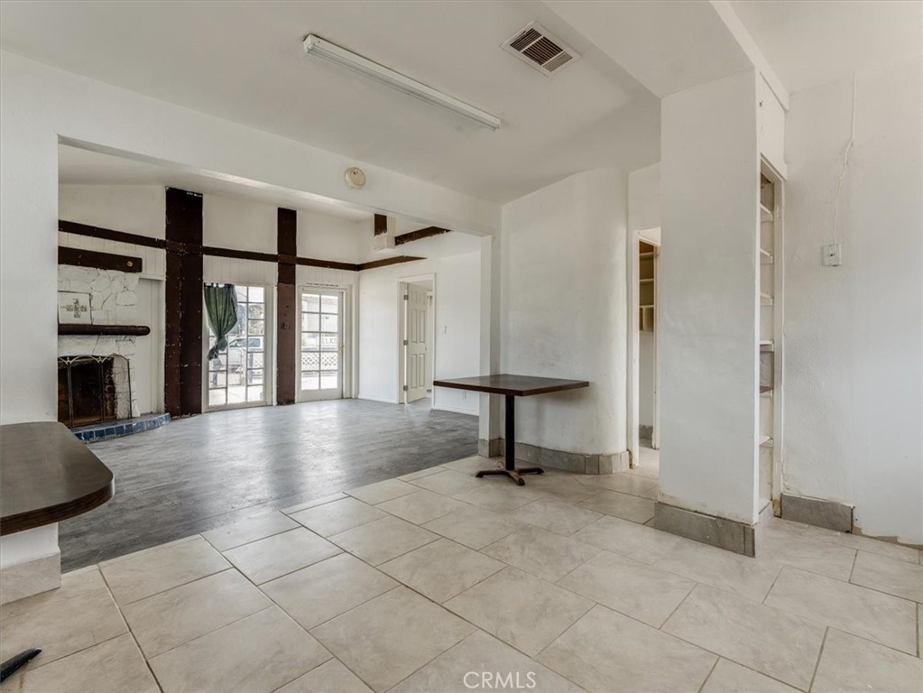396 Pier Avenue Oceano, CA 93445 - Photo 13 of 24 a view of an empty room with a fireplace and a window