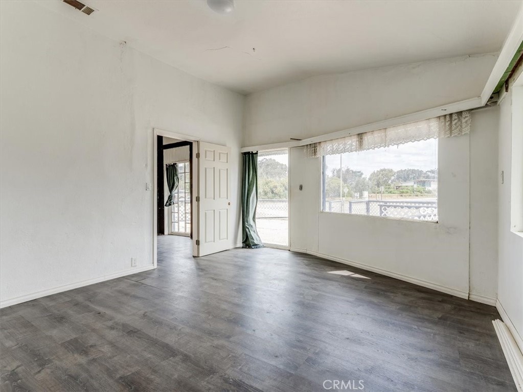 396 Pier Avenue Oceano, CA 93445 - Photo 14 of 24 a view of an empty room with a window and wooden floor