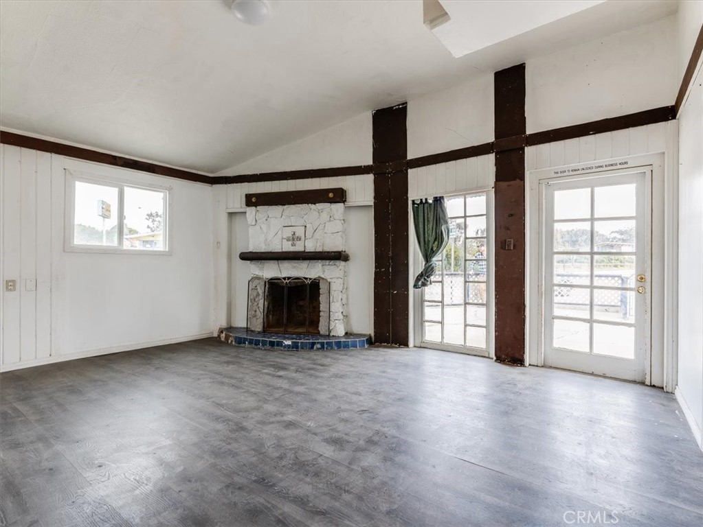 396 Pier Avenue Oceano, CA 93445 - Photo 8 of 24 an empty room with windows and a fireplace