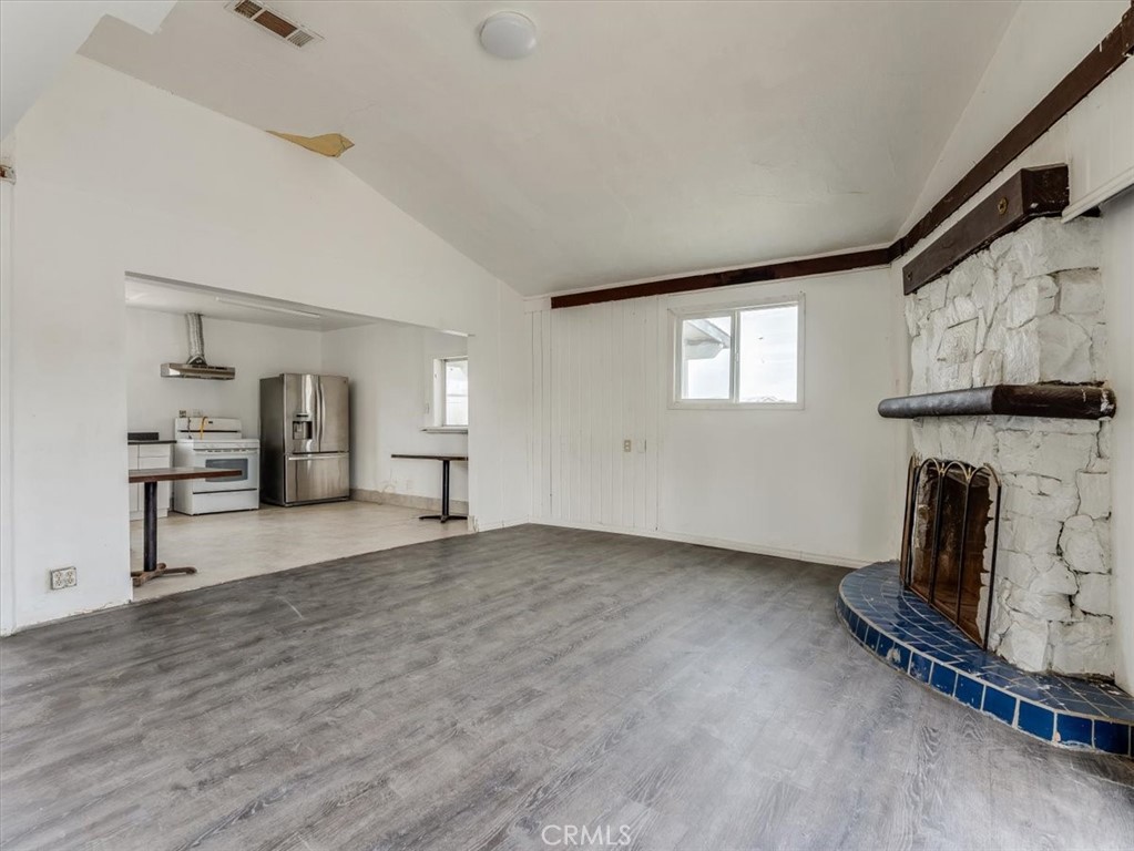 396 Pier Avenue Oceano, CA 93445 - Photo 10 of 24 a view of empty room with a fireplace and wooden floor