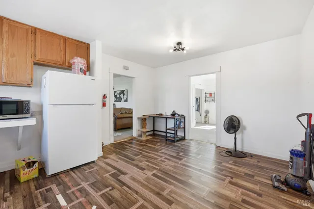 a kitchen with stainless steel appliances granite countertop a refrigerator and a stove