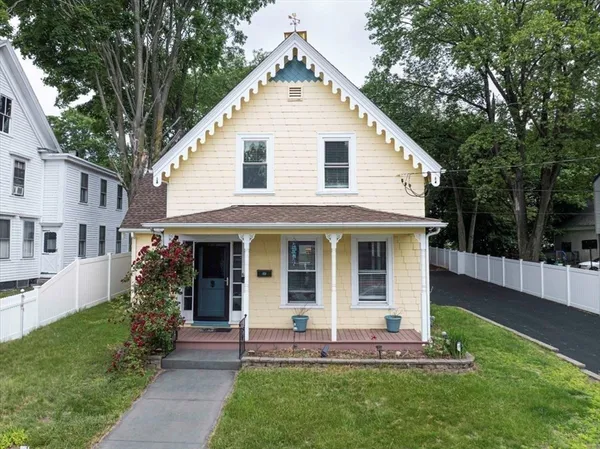 a view of a house with a yard and porch
