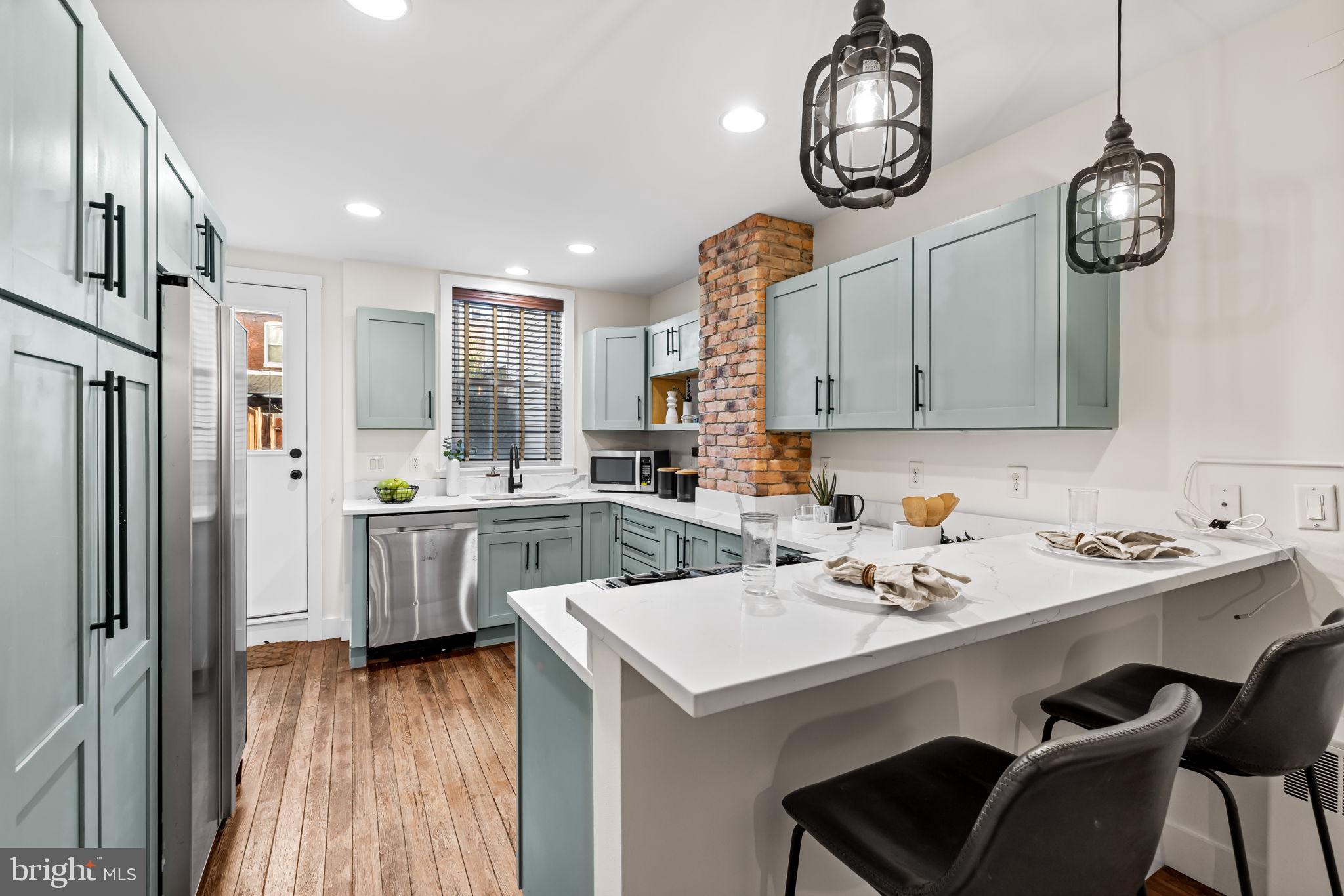 1459 Woodall Street Baltimore, MD 21230 - Photo 13 of 34 a kitchen with a sink a stove a refrigerator cabinets and dining table