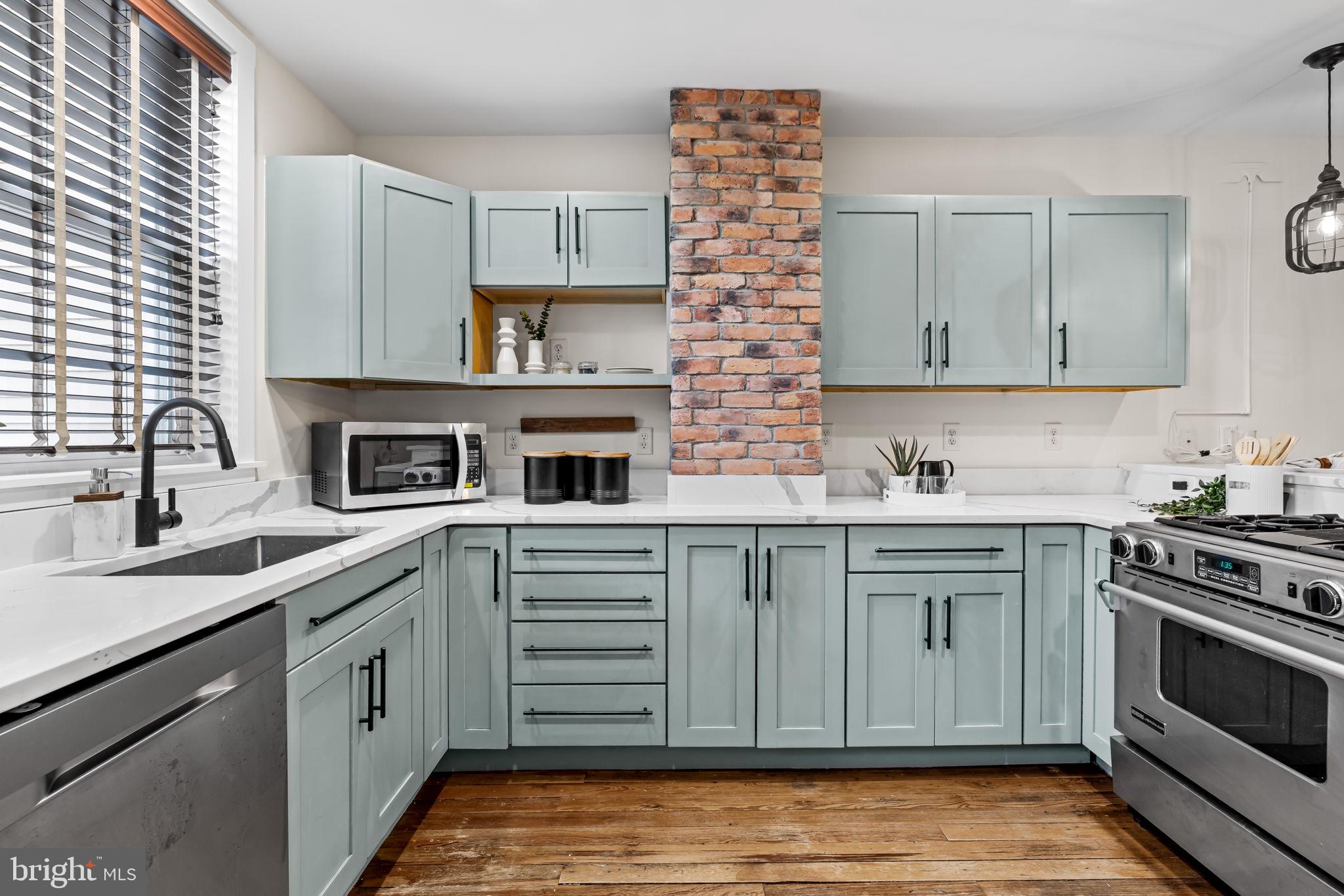 1459 Woodall Street Baltimore, MD 21230 - Photo 14 of 34 a kitchen with stainless steel appliances granite countertop a stove sink and cabinets