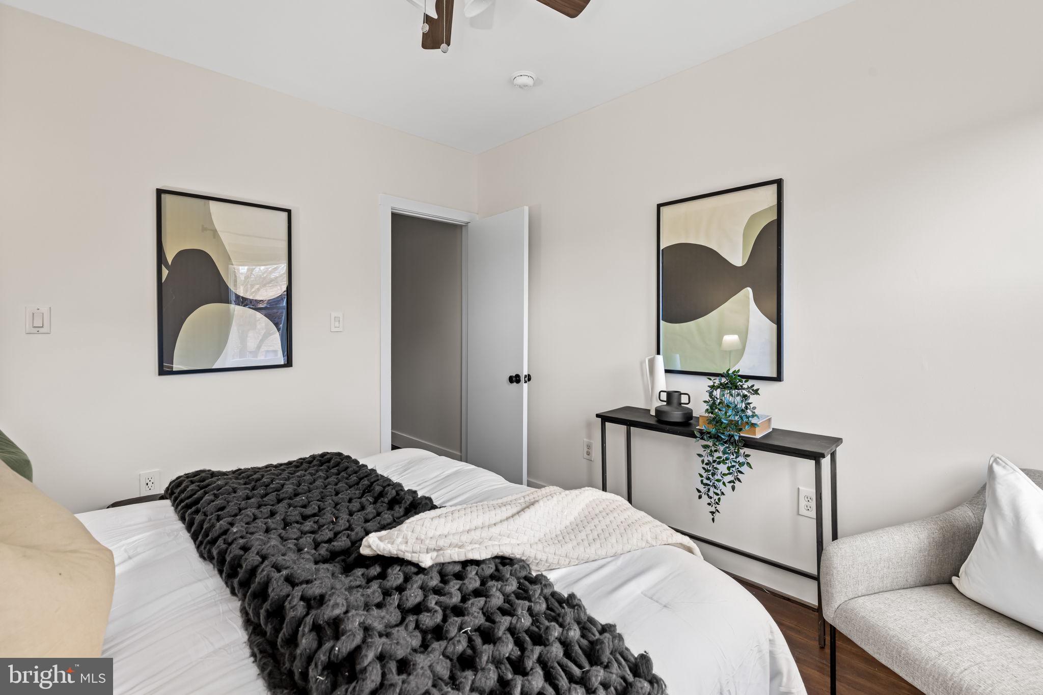 1459 Woodall Street Baltimore, MD 21230 - Photo 20 of 34 a bedroom with a bed and dresser with mirror