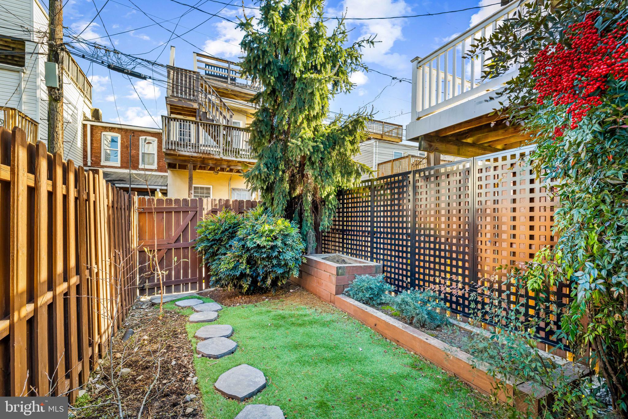 1459 Woodall Street Baltimore, MD 21230 - Photo 33 of 34 a view of a back yard of the house with a garden