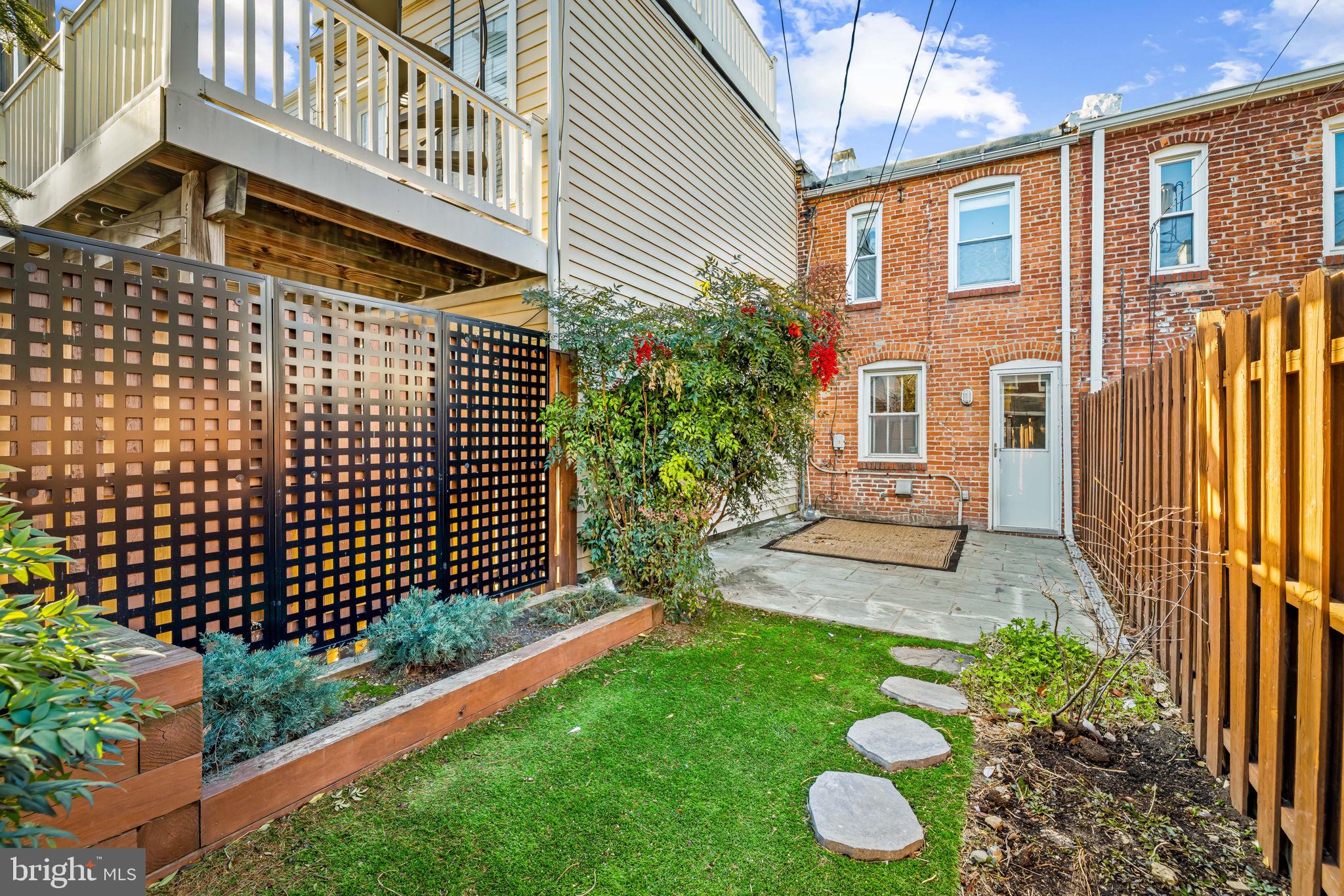 1459 Woodall Street Baltimore, MD 21230 - Photo 34 of 34 a front view of a house with a garden