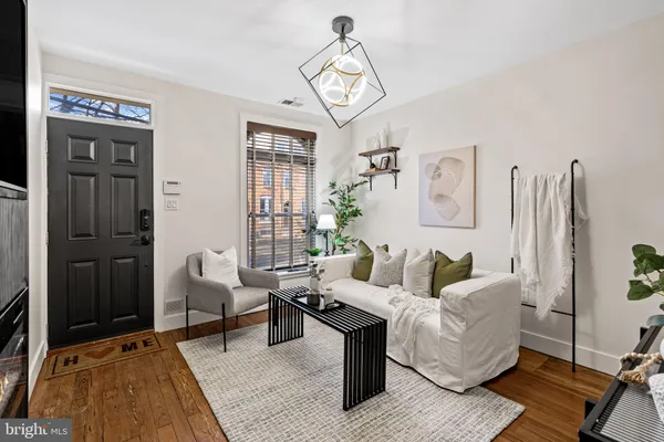 a living room with furniture a rug and a chandelier