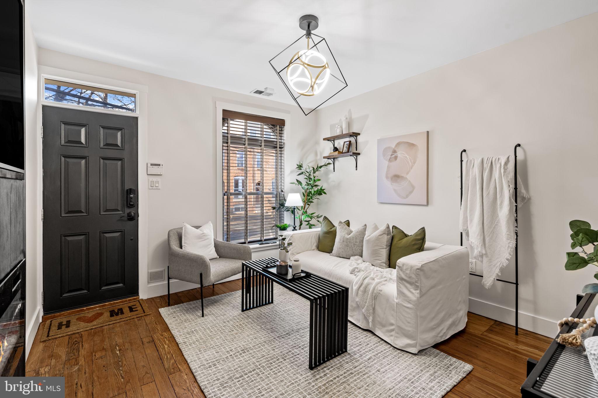 1459 Woodall Street Baltimore, MD 21230 - Photo 8 of 34 a living room with furniture a rug and a chandelier
