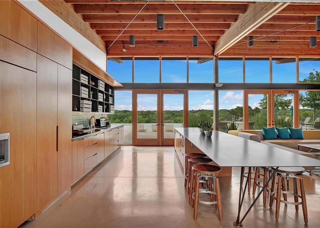 208 Wolf Springs Road Georgetown, TX 78628 - Photo 32 of 32 An open concept kitchen and living area showcases a soaring wood-beamed ceiling and polished concrete flooring.