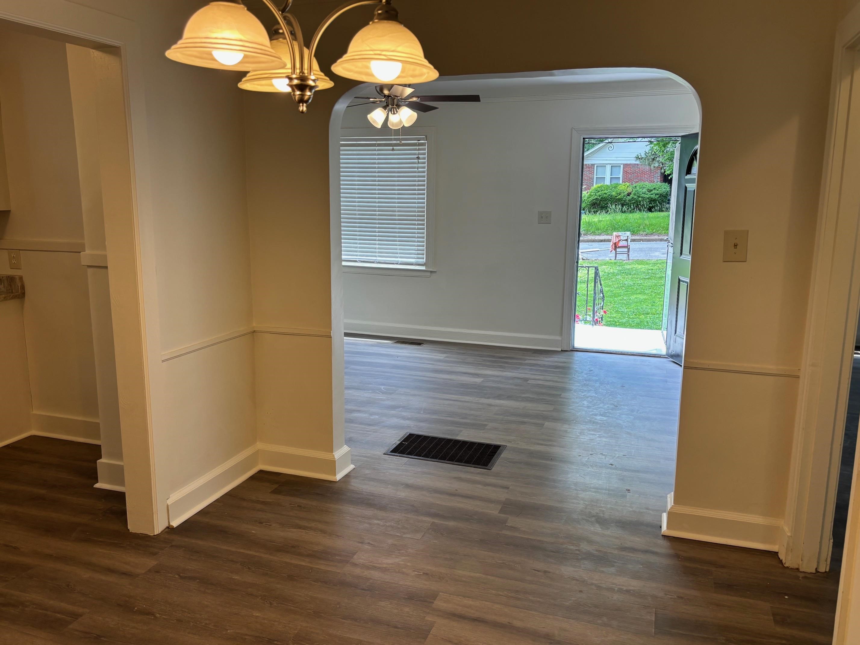 3750 Kearney Avenue Memphis, TN 38111 - Photo 9 of 14 an empty room with wooden floor mirror and windows