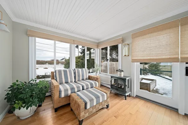 a bedroom with a bed wooden floor and window