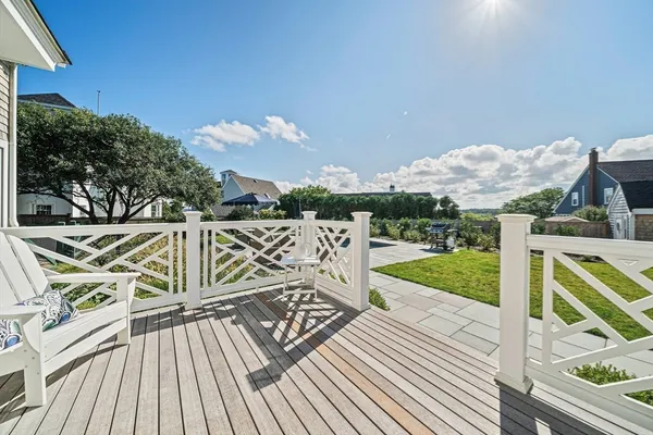 a view of balcony with wooden floor and fence