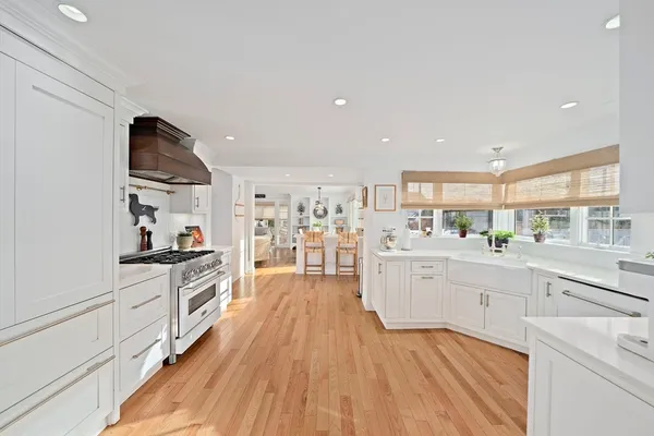 a kitchen with stainless steel appliances a white cabinet and a stove top oven