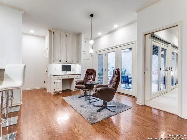 a living room with furniture a rug and a chandelier