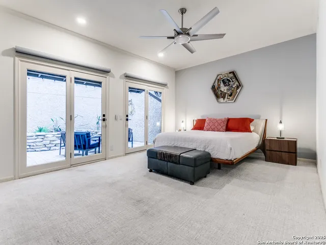 a bedroom with a large bed and a chandelier