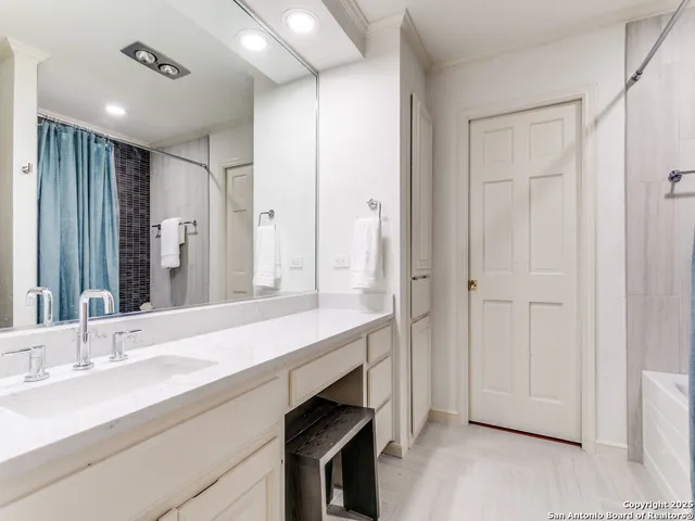 a bathroom with a double vanity sink and a mirror