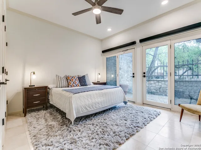 a bedroom with a large bed and a large window